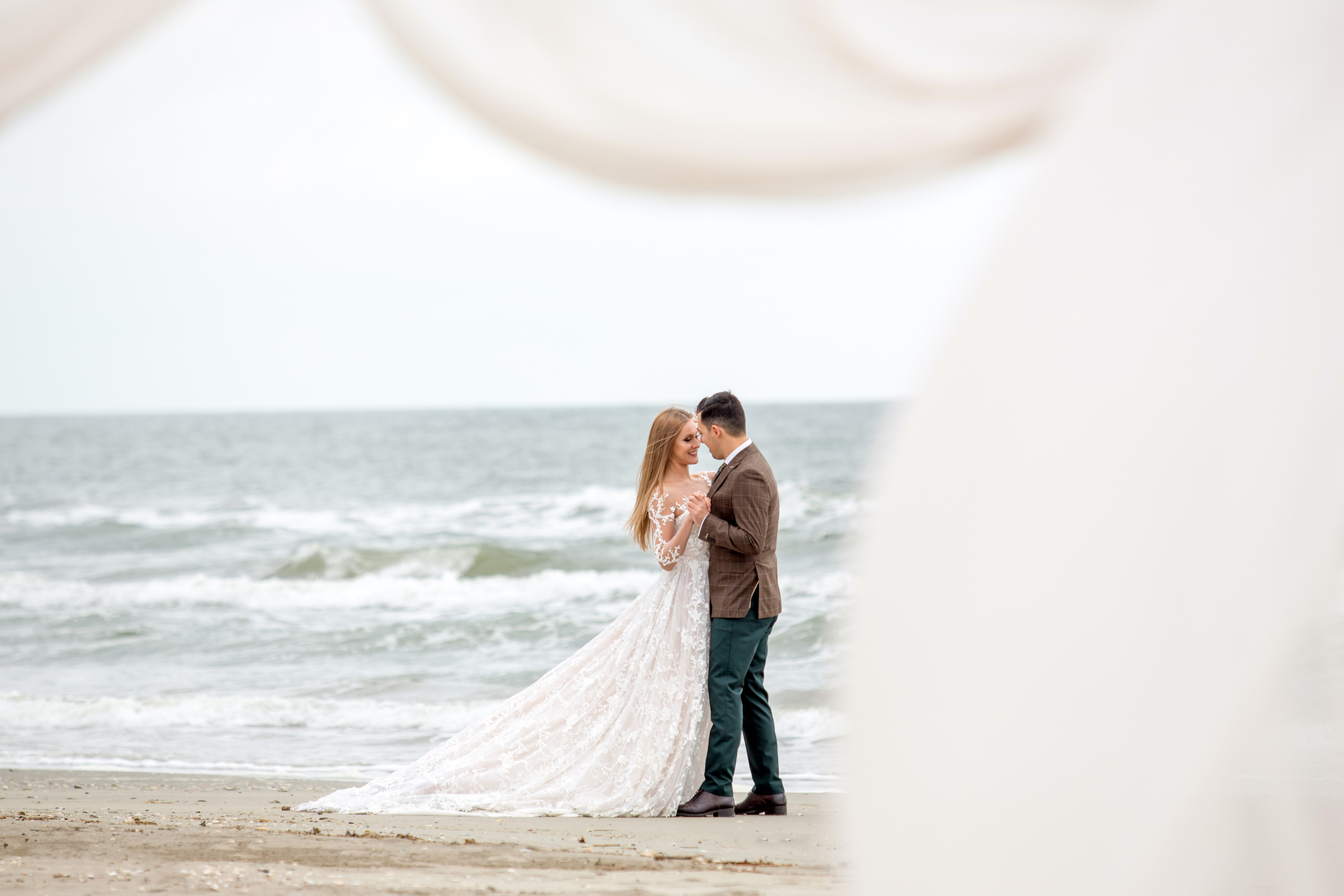 Beautiful wedding couple posing on beach