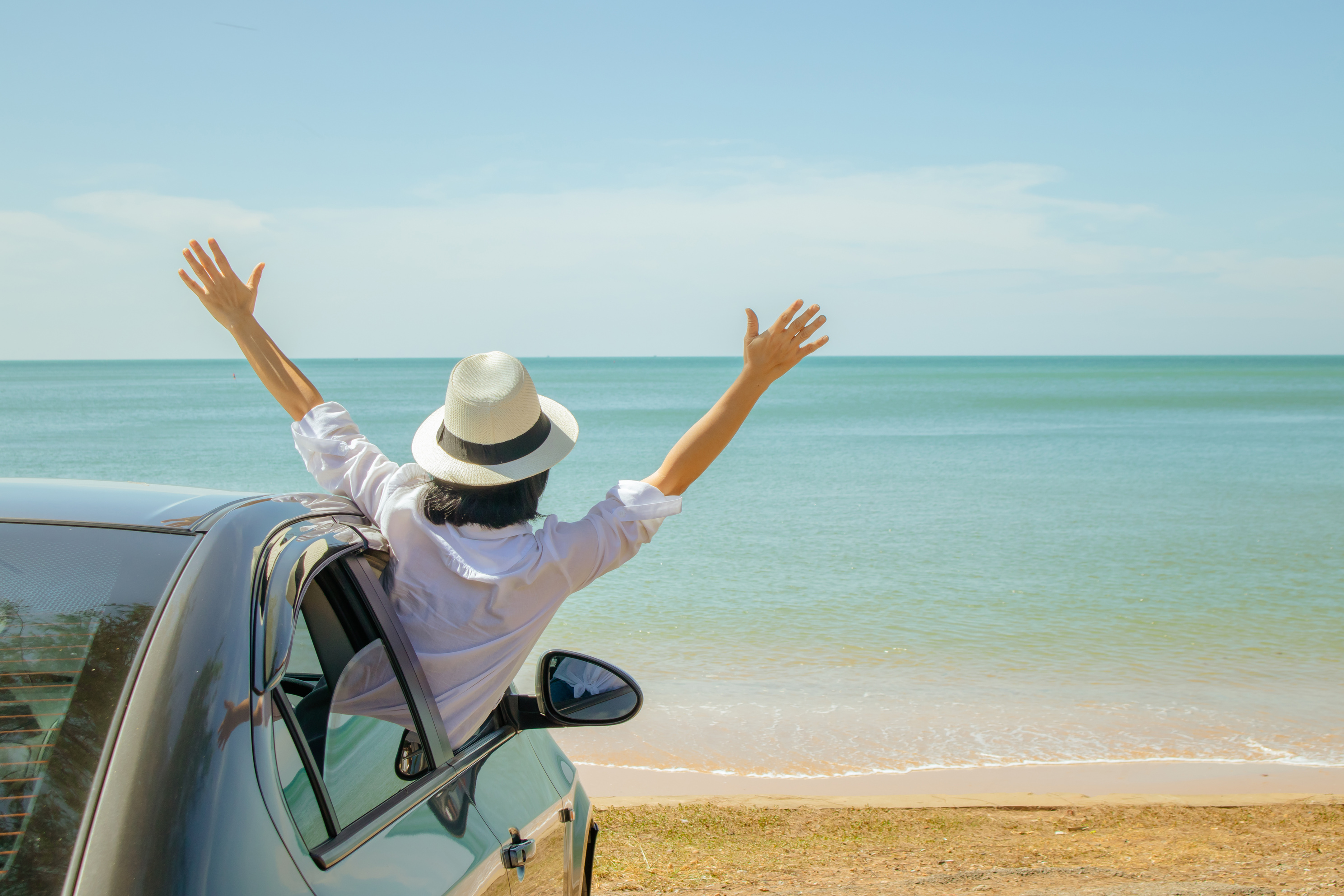 Family car trip at the sea, Asian woman feeling happiness.